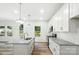 A bright kitchen with stainless steel appliances, granite countertops, and access to outdoor living at 411 Patience Dr, Concord, NC 28025