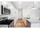 The kitchen offers an island with granite countertops, stainless appliances, and an electric range at 411 Patience Dr, Concord, NC 28025