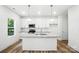 The open kitchen has a center island with sink, granite countertops, and stainless steel appliances at 411 Patience Dr, Concord, NC 28025