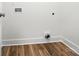 A well-lit laundry area with hardwood flooring and utility connections at 411 Patience Dr, Concord, NC 28025