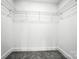 Walk-in closet featuring carpeted flooring and wire shelving for optimal storage and organization at 411 Patience Dr, Concord, NC 28025