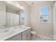 Bright bathroom featuring modern vanity with double sinks, large mirror, and a shower/tub with curtain at 507 Yucatan Dr # 71, Waxhaw, NC 28173