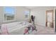 Bright bedroom with floral bedding, carpet floors, and natural light from two windows at 507 Yucatan Dr # 71, Waxhaw, NC 28173