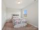 Bright bedroom features floral bedspread, plush carpet, and a window providing natural light at 507 Yucatan Dr # 71, Waxhaw, NC 28173