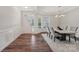 Bright dining room featuring wood floors, wainscoting, a modern chandelier and large windows at 507 Yucatan Dr # 71, Waxhaw, NC 28173