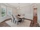 Dining room showcasing modern chandelier, marble table, and wainscoting detail at 507 Yucatan Dr # 71, Waxhaw, NC 28173
