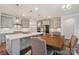 Island kitchen boasts stainless appliances, gray cabinetry, quartz countertops, and pendant lighting at 507 Yucatan Dr # 71, Waxhaw, NC 28173