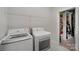 Bright laundry room featuring modern washer and dryer, tile floors, and closet at 507 Yucatan Dr # 71, Waxhaw, NC 28173