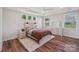 Comfortable main bedroom featuring tray ceiling, three windows, and stylish decor at 507 Yucatan Dr # 71, Waxhaw, NC 28173
