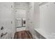 Well-lit mud room featuring bench, coat hooks, wood floors, and access to the laundry room at 507 Yucatan Dr # 71, Waxhaw, NC 28173