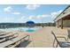 Community pool and sundeck with plenty of lounge chairs and neighborhood views under a sunny sky at 507 Yucatan Dr # 71, Waxhaw, NC 28173