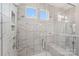 Modern shower featuring white marble tile, glass enclosure, and built-in bench at 507 Yucatan Dr # 71, Waxhaw, NC 28173