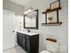 Stylish bathroom with shiplap walls, a dark vanity, and decorative shelving at 5105 Paisano Ln, Waxhaw, NC 28173