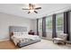 Bright bedroom features large windows, plush carpet, and ceiling fan at 5105 Paisano Ln, Waxhaw, NC 28173