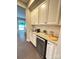 Convenient butler's pantry features a granite countertop, wine cooler, and white cabinets at 5105 Paisano Ln, Waxhaw, NC 28173