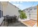 Backyard with a patio set, brick paving, and metal planters with climbing vegetables at 514 Bent Leaf Ct, Fort Mill, SC 29708