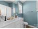 Bathroom featuring blue walls, white cabinets, and a window over the toilet at 514 Bent Leaf Ct, Fort Mill, SC 29708