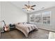 Bright bedroom featuring a ceiling fan, three sunny windows, and neutral carpet at 514 Bent Leaf Ct, Fort Mill, SC 29708