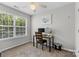 Bedroom with neutral walls, window view, and desk with computer monitors at 514 Bent Leaf Ct, Fort Mill, SC 29708