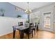 Cozy dining room with hardwood floors, a stylish chandelier, and a view of the backyard at 514 Bent Leaf Ct, Fort Mill, SC 29708