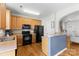 Well-appointed kitchen with wooden cabinetry, black appliances, and hardwood floors at 514 Bent Leaf Ct, Fort Mill, SC 29708