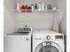 Modern laundry room with a front loading washer and dryer and overhead storage at 514 Bent Leaf Ct, Fort Mill, SC 29708