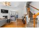 Bright and airy living room with a fireplace, hardwood floors, and an open staircase at 514 Bent Leaf Ct, Fort Mill, SC 29708