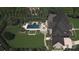Stunning aerial view of backyard featuring a pool, hot tub, lounge chairs, fire pit, and seating area at 5311 Carmel Park Dr, Charlotte, NC 28211