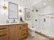 Modern bathroom with wood vanity, marble countertop, glass enclosed shower with marble walls at 5311 Carmel Park Dr, Charlotte, NC 28211