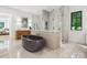 Modern bathroom featuring soaking tub, glass enclosed shower, dual vanity with wooden cabinets, and tiled floors at 5311 Carmel Park Dr, Charlotte, NC 28211