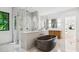 Spa-like bathroom featuring a modern soaking tub, glass-enclosed shower, and dual vanity with wood cabinets at 5311 Carmel Park Dr, Charlotte, NC 28211
