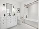 Bright bathroom featuring a white vanity with black fixtures, a large mirror, and a tiled shower-tub combination at 5311 Carmel Park Dr, Charlotte, NC 28211