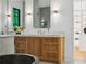 Elegant bathroom vanity with marble countertop, wooden cabinetry, modern lighting, and decorative mirror at 5311 Carmel Park Dr, Charlotte, NC 28211