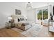 Bedroom featuring a large bed, hardwood floors, large window and modern decorative furnishings at 5311 Carmel Park Dr, Charlotte, NC 28211