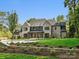 Beautiful home with landscaped yard, stone accents, and a well-maintained green lawn at 5311 Carmel Park Dr, Charlotte, NC 28211