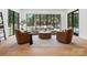 Cozy living room featuring a large window with a view of the outdoor pool and lush landscaping at 5311 Carmel Park Dr, Charlotte, NC 28211