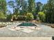 Backyard pool installation featuring stone tile work and a wooded area, creating a relaxing oasis at 5311 Carmel Park Dr, Charlotte, NC 28211