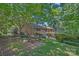 Secluded backyard with picnic table, trees and lush landscaping surrounding the home at 5441 Wintercrest Ln, Charlotte, NC 28209