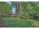 Beautiful home with a large, lush backyard, mature trees and landscaping at 5441 Wintercrest Ln, Charlotte, NC 28209