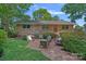 Brick patio with outdoor seating, grill, and lush landscaping at 5441 Wintercrest Ln, Charlotte, NC 28209