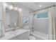 Well-lit bathroom with white subway tile, tub-shower, a modern mirror and sink, creating a clean and relaxing space at 5441 Wintercrest Ln, Charlotte, NC 28209