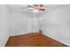 Bedroom with wooden floors, white walls, and a ceiling fan; a closet door adds functionality and style at 5441 Wintercrest Ln, Charlotte, NC 28209