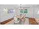 Elegant dining room with a rustic wood table, stylish chandelier, and ample natural light at 5441 Wintercrest Ln, Charlotte, NC 28209