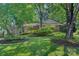 Well-manicured front yard with lush landscaping and mature trees at 5441 Wintercrest Ln, Charlotte, NC 28209