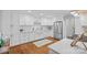 Modern kitchen with white cabinets, stainless steel appliances, and hardwood floors at 5441 Wintercrest Ln, Charlotte, NC 28209