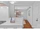Modern kitchen featuring white cabinets, marble countertops, and stainless steel appliances, seamlessly flowing into the dining area at 5441 Wintercrest Ln, Charlotte, NC 28209