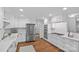 Updated kitchen with white cabinets, stainless steel appliances, and hardwood floors at 5441 Wintercrest Ln, Charlotte, NC 28209
