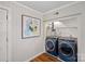 Modern laundry room with blue washer and dryer, built in shelving and decor at 5441 Wintercrest Ln, Charlotte, NC 28209