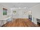 Bright laundry room with hardwood floors, desk, artwork, and modern washer and dryer at 5441 Wintercrest Ln, Charlotte, NC 28209