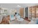 Open living room boasts hardwood floors, custom built-ins, brick fireplace, with comfortable seating; laundry in background at 5441 Wintercrest Ln, Charlotte, NC 28209